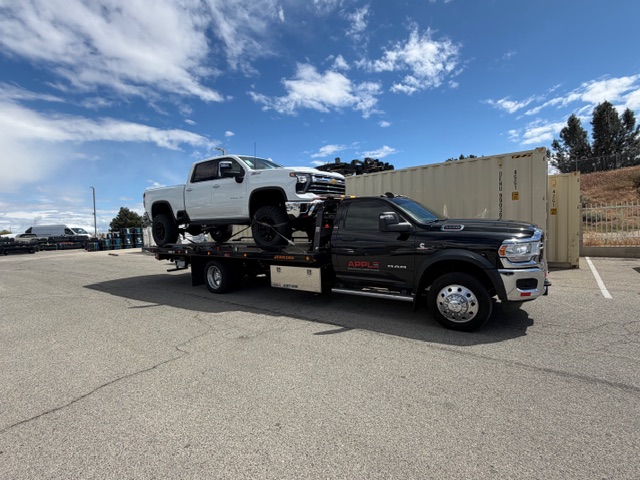 White pickup loaded clean on Apple Roadside flatbed
